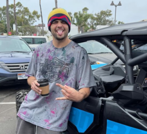 Noah Centineo posing for photo with his car
