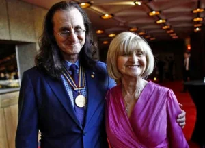 Caption: Musician Geddy Lee with his wife