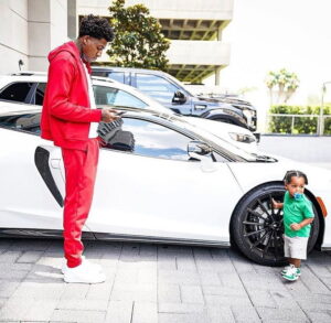NBA Youngboy standing outside his car