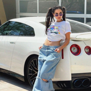 SSSniperwolf posing for a photo with her car