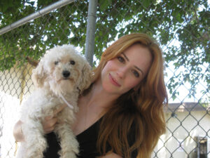 Caption: Jaime Ray Newman with her dog