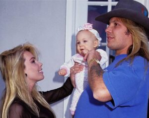 Caption: Sharise Ruddell with her daughter and Vince Neil